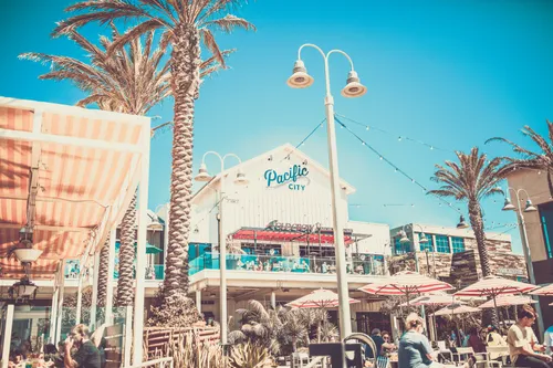 Pier and beachfront in Huntington Beach — "Surf City USA" with roughly 9.5 miles of continuous coastline and one of California's signature surf scenes
