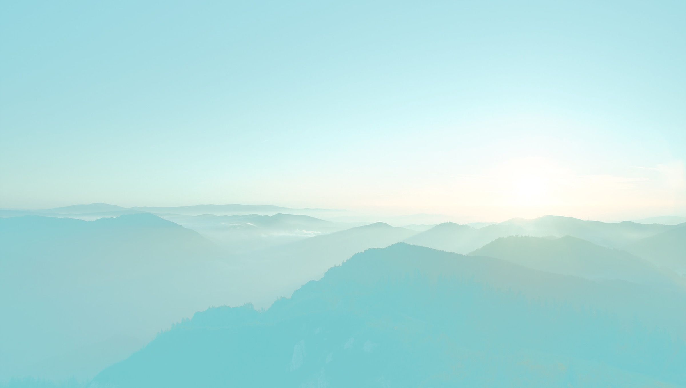 Pastel mountain ridges at sunrise — aspirational landscape